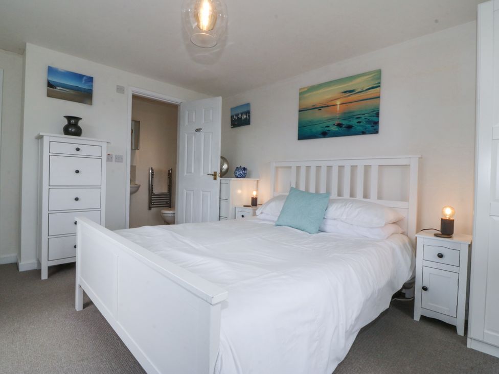 A bedroom with a bed and nightstand at Bryn Awel in Mynytho near Abersoch