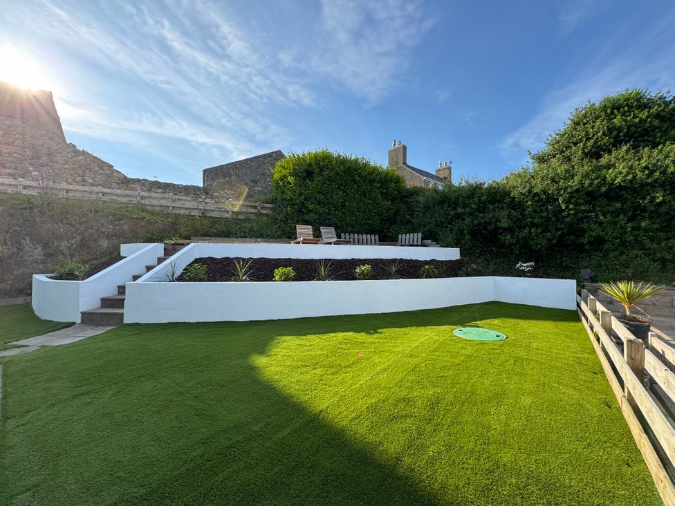 A garden with steps and plants at Cromlin Glas in Abersoch