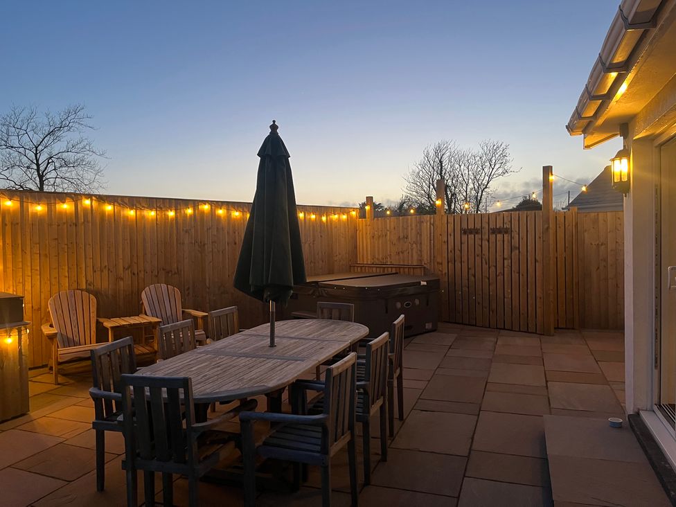 An outdoor area with a dining table and chairs at Gilfach in Abersoch