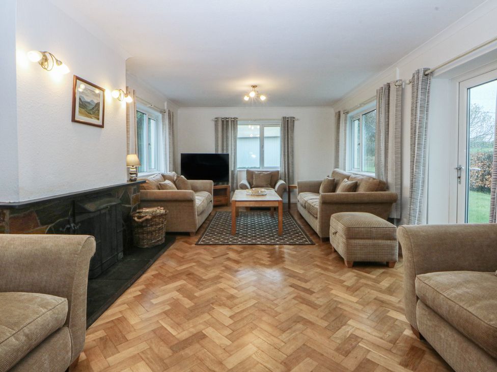 A living room with sofas and a TV at Lane End in Abersoch