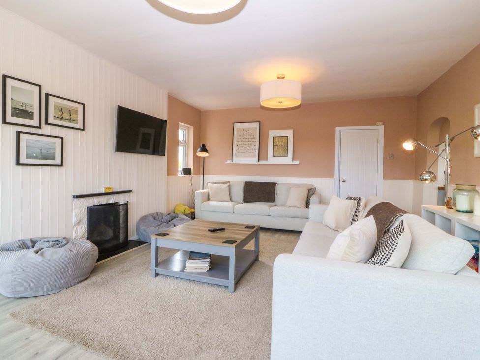 A living room with a sofa and coffee table at Nyth Y Fran in Abersoch