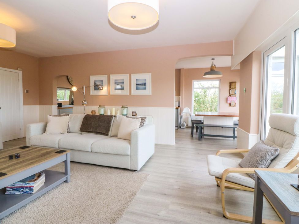A living room with a couch and coffee table at Nyth Y Fran in Abersoch