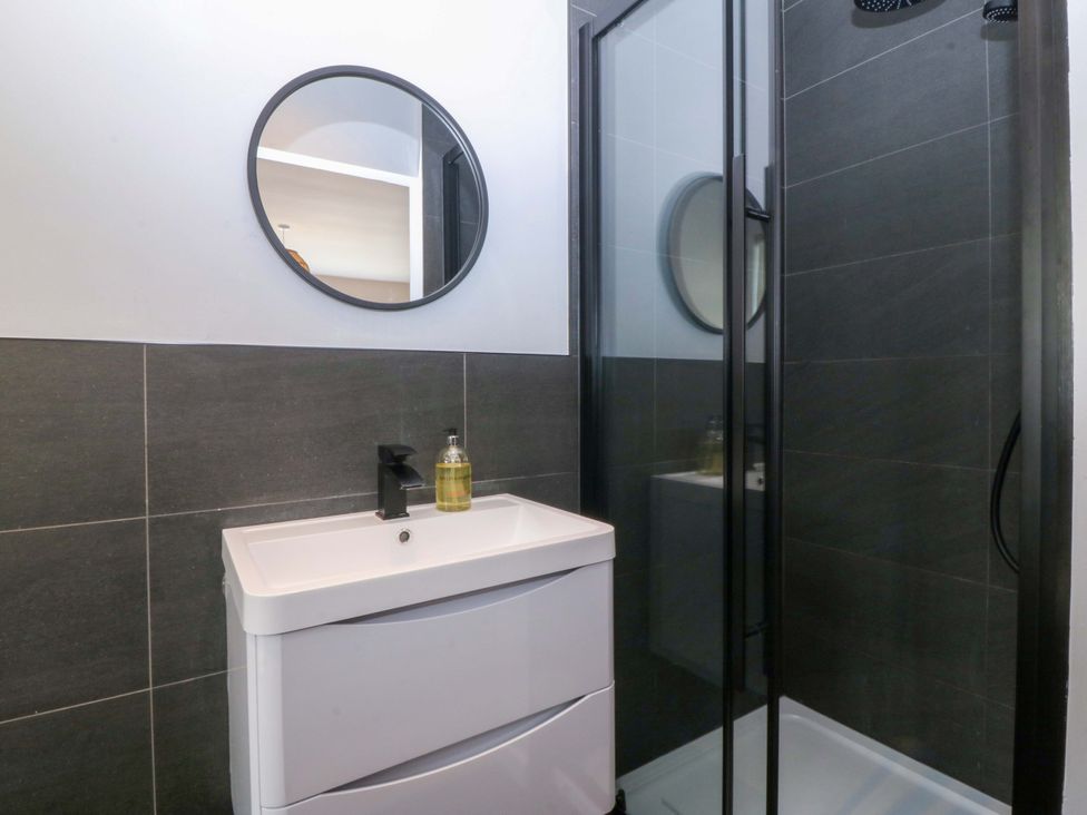 A bathroom with a sink and shower at Nyth Y Fran in Abersoch