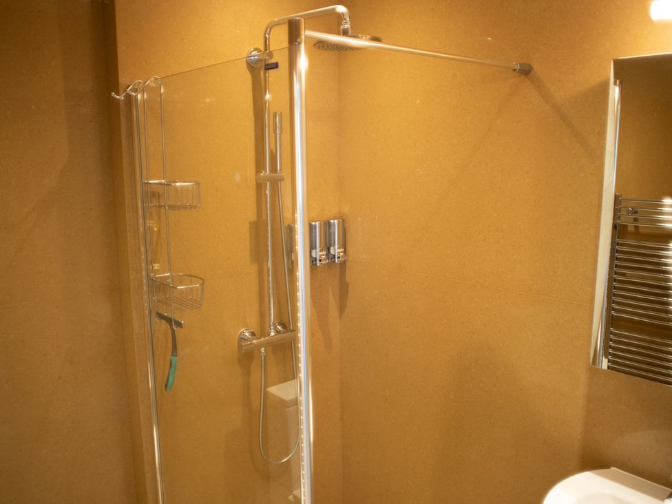 A shower with glass panel and chrome fittings at Pen Y Sarn Sarn Bach near Abersoch