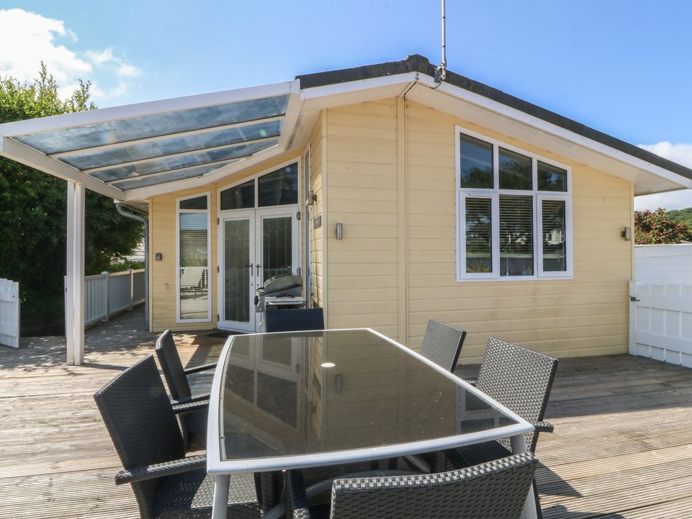 An outdoor dining area with a table and chairs at The Warren D26 Abersoch
