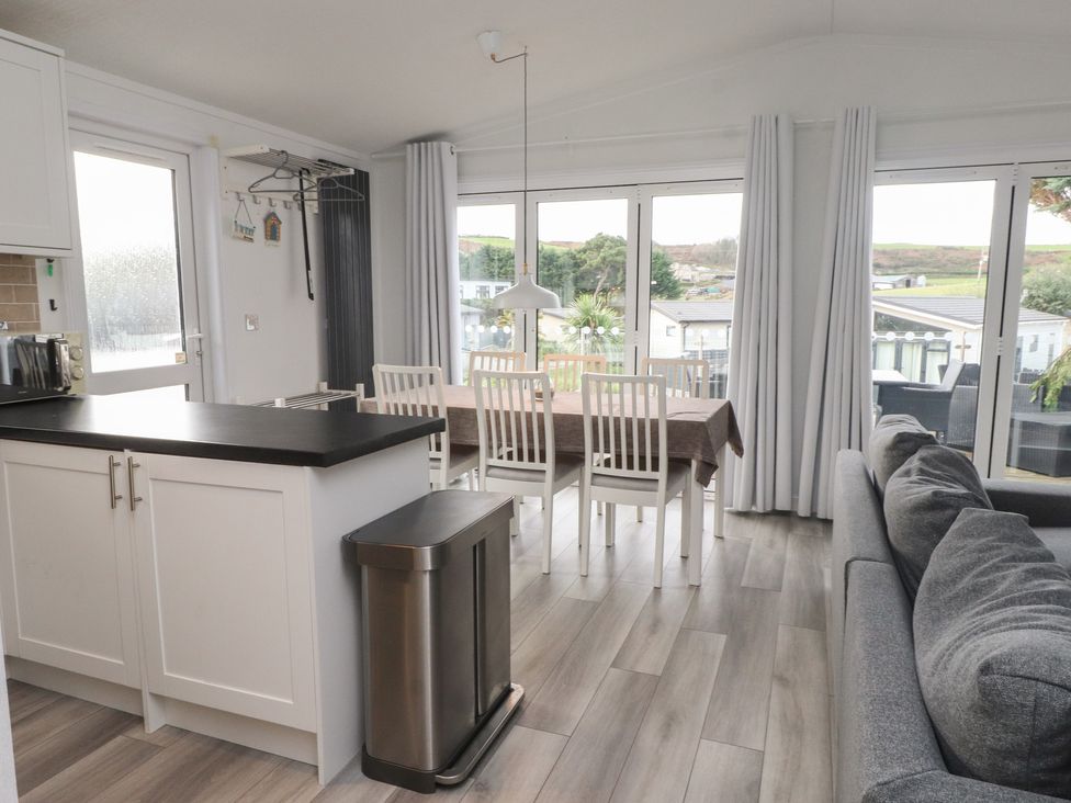 A kitchen with dining area and sofa at The Warren D7 Abersoch