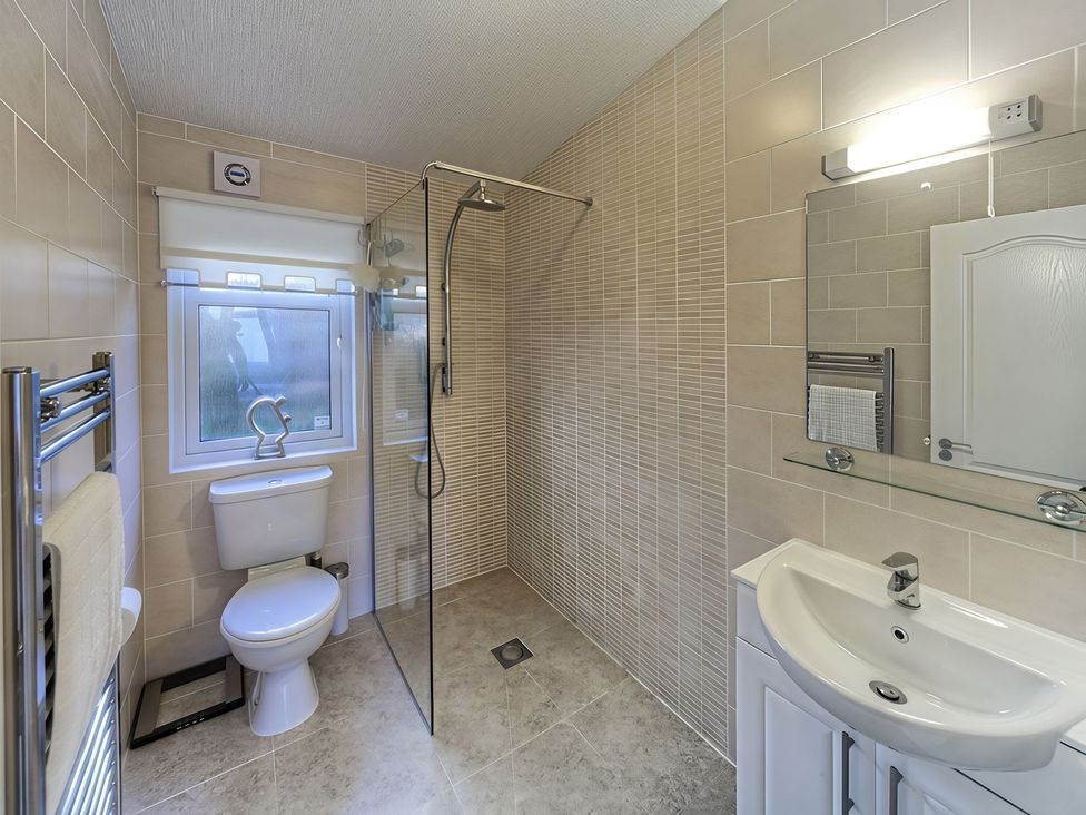 A bathroom with a shower, toilet, and sink at The Warren D7 in Abersoch