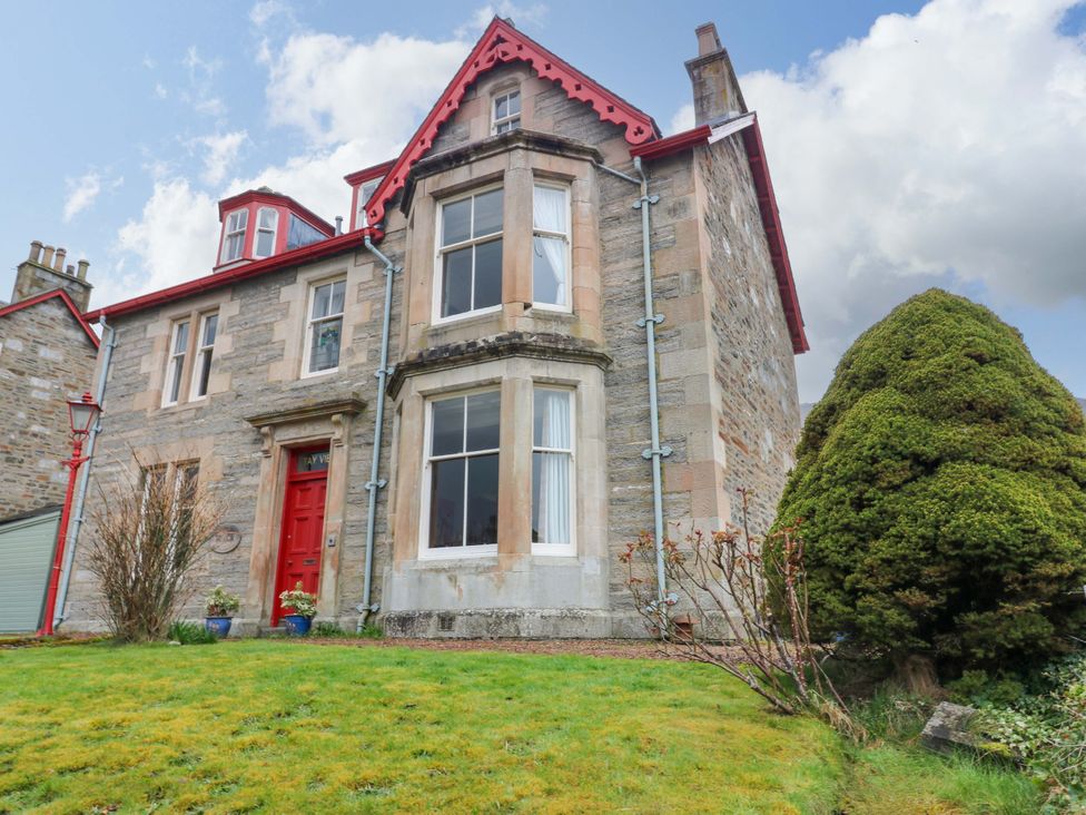 A house with a red door and windows at Tayview in Killin