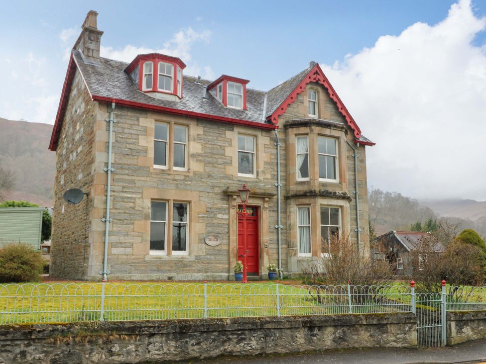 A house with windows and a red door at Tayview in Killin