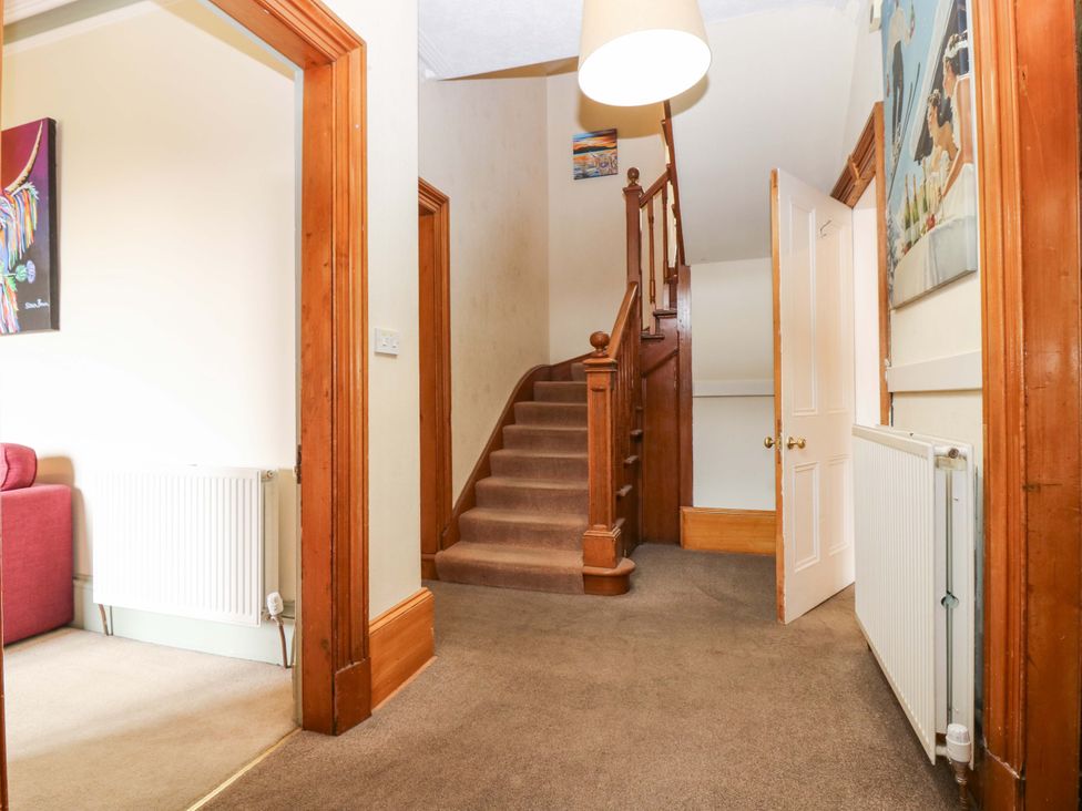 A hallway with a staircase and a door at Tayview in Killin