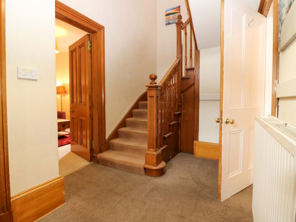 A hallway with a staircase and a door at Tayview in Killin