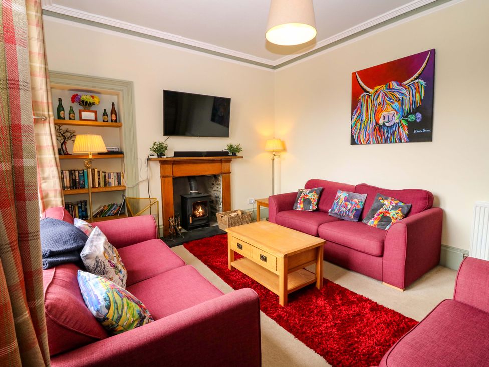 A living room with furniture and a television at Tayview in Killin