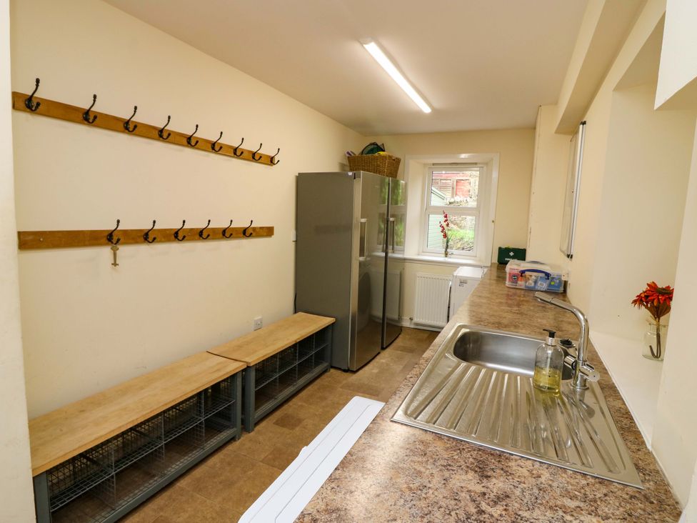 A kitchen with hooks, a fridge, and a sink at Tayview in Killin