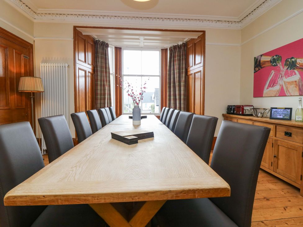 A dining room with a large table and chairs at Tayview in Killin