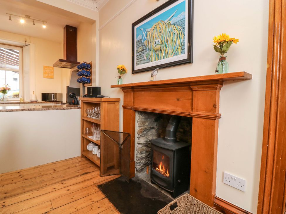 A kitchen with a fireplace and stove at Tayview in Killin