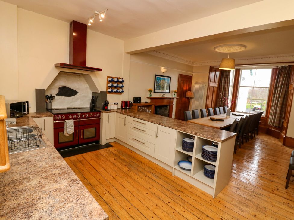 A kitchen with a stove and dining area at Tayview in Killin