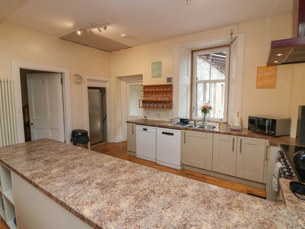 A kitchen with appliances and a large countertop at Tayview in Killin
