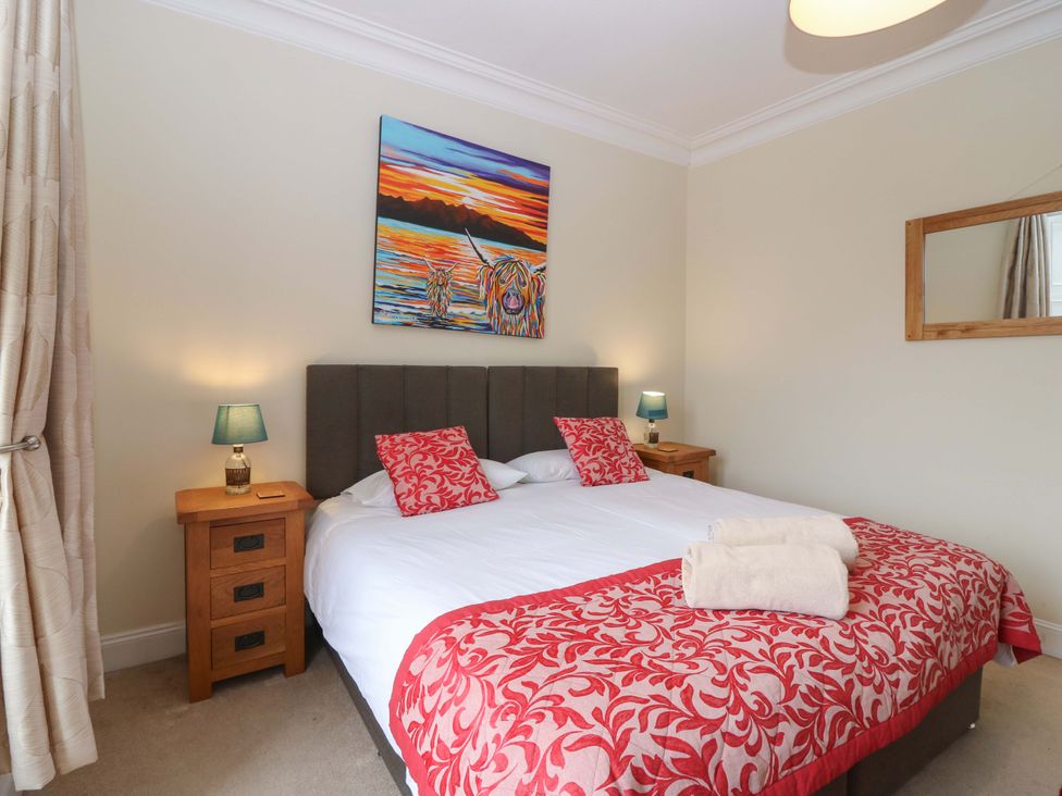 A bedroom with a bed and nightstand at Tayview in Killin