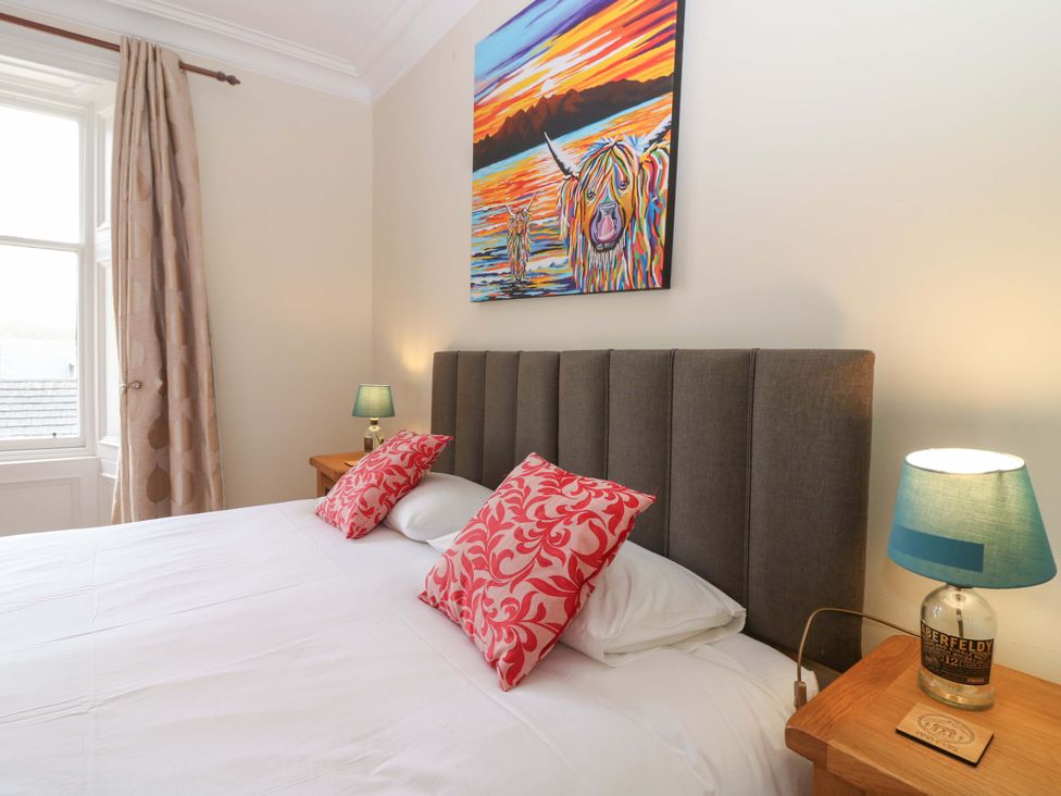 A bedroom with a bed and artwork at Tayview in Killin