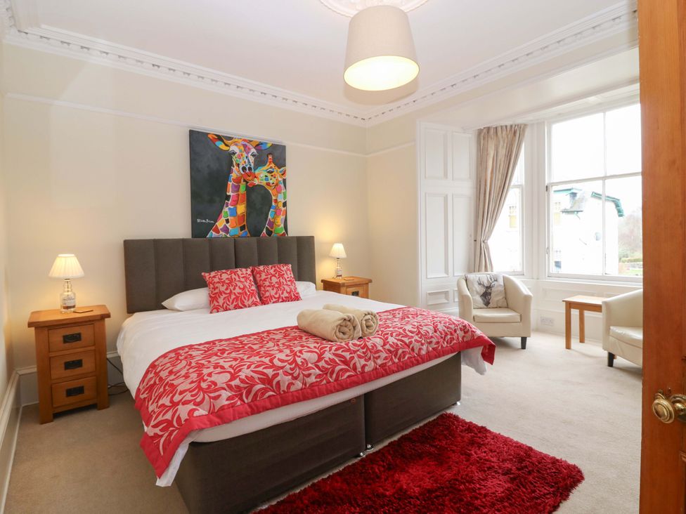 A bedroom with a bed and a painting at Tayview in Killin