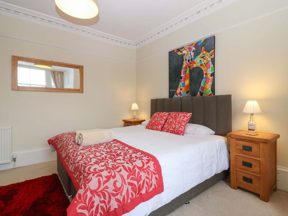 A bedroom with a bed and artwork at Tayview in Killin