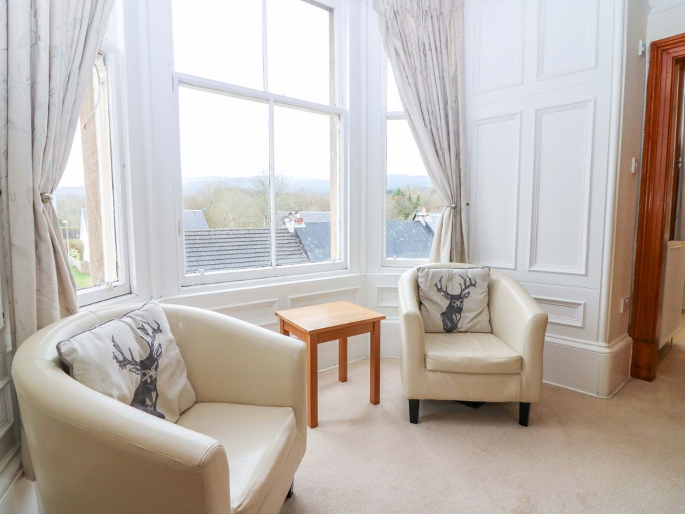 A living room with two chairs and a table at Tayview in Killin