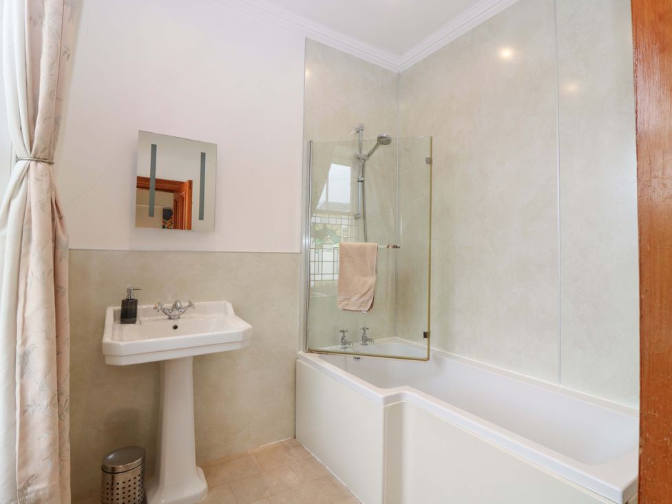 A bathroom with a bathtub and sink at Tayview in Killin