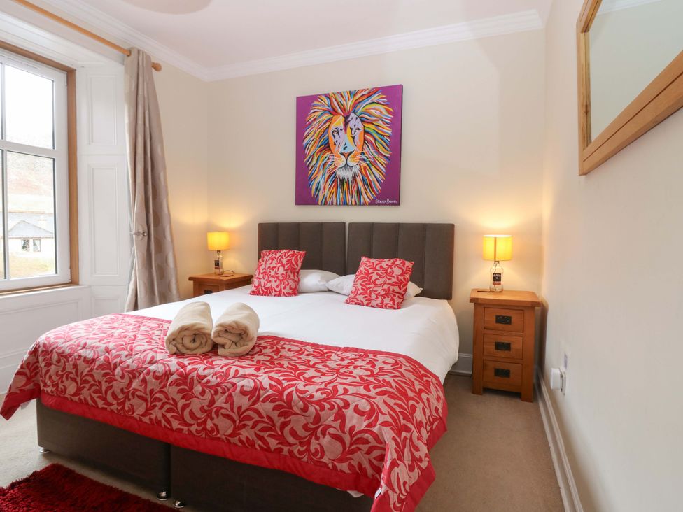 A bedroom with a bed and artwork at Tayview in Killin