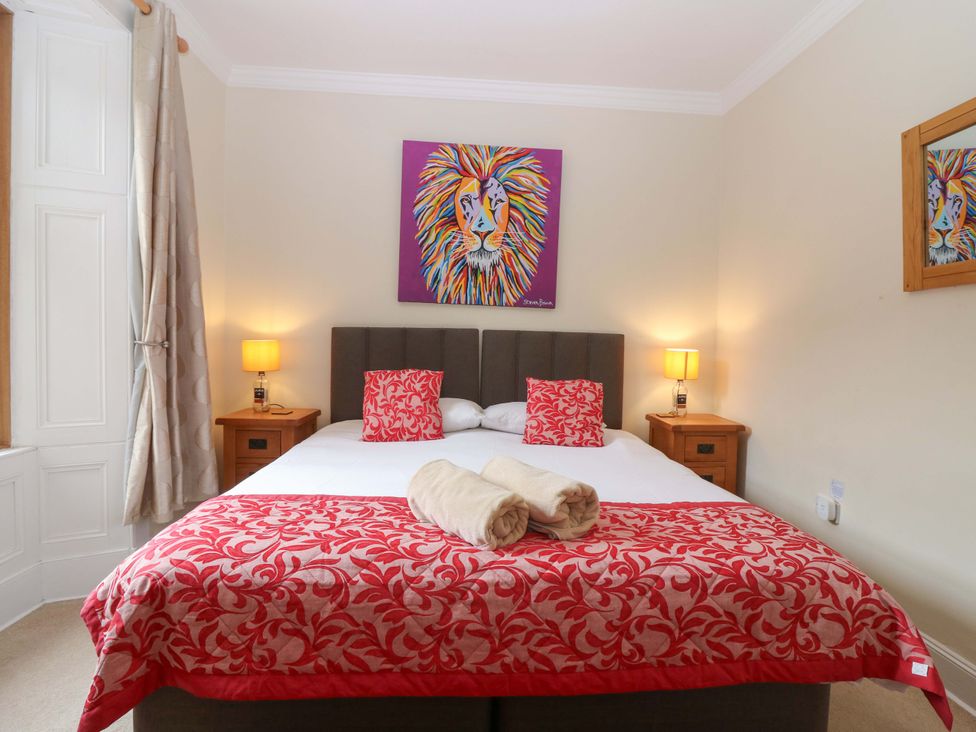 A bedroom with a double bed and wall art at Tayview in Killin