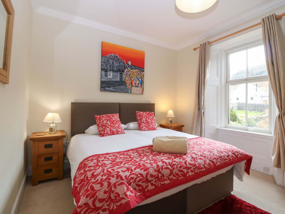 A bedroom with a bed and painting at Tayview in Killin