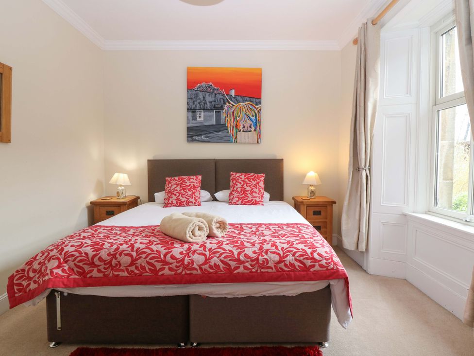 A bedroom with a bed and artwork at Tayview in Killin