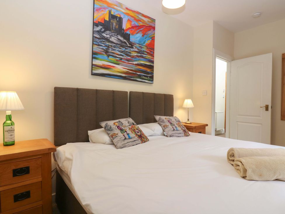 A bedroom with a bed and bedside tables at Tayview in Killin