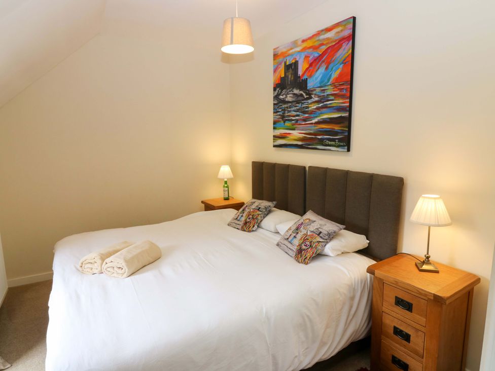 A bedroom with a bed and nightstand at Tayview in Killin
