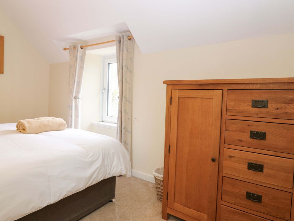 A bedroom with a bed and a drawer chest at Tayview in Killin