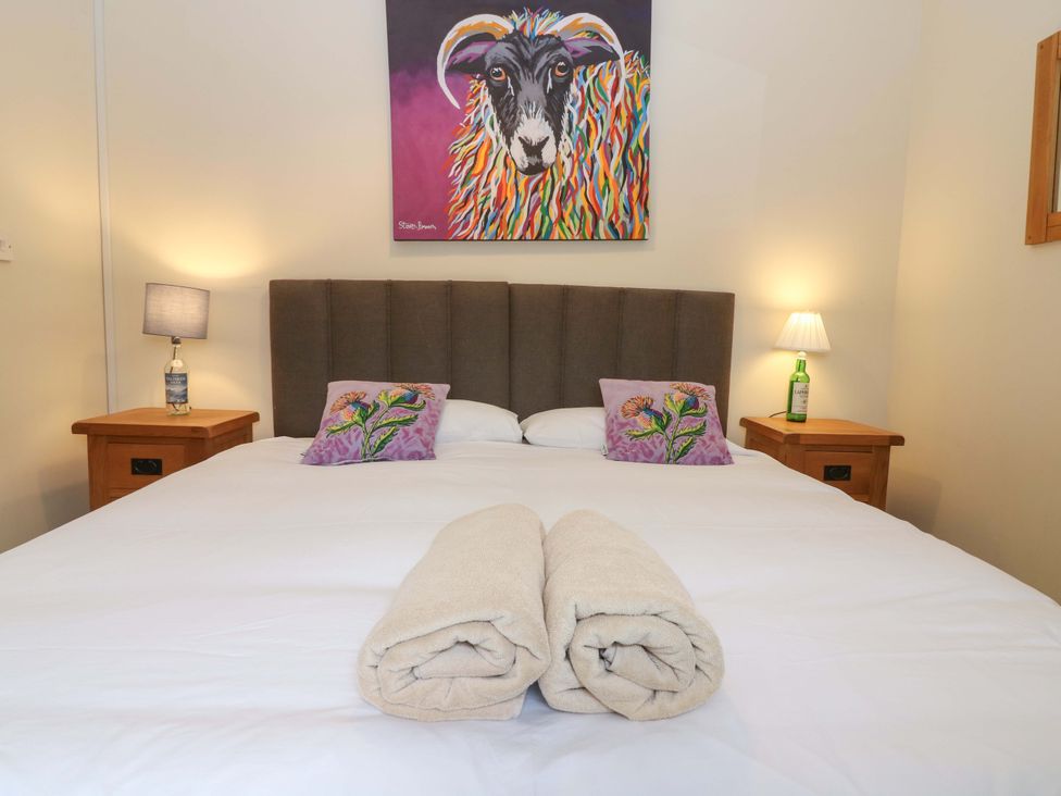 A bedroom with a bed and artwork at Tayview in Killin