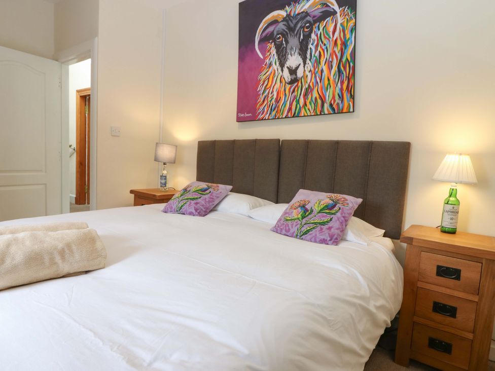 A bedroom with a bed and side tables at Tayview in Killin