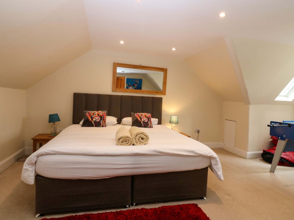 A bedroom with a bed and a foosball table at Tayview in Killin