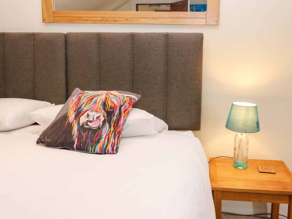 A bedroom with a bed and a lamp at Tayview in Killin