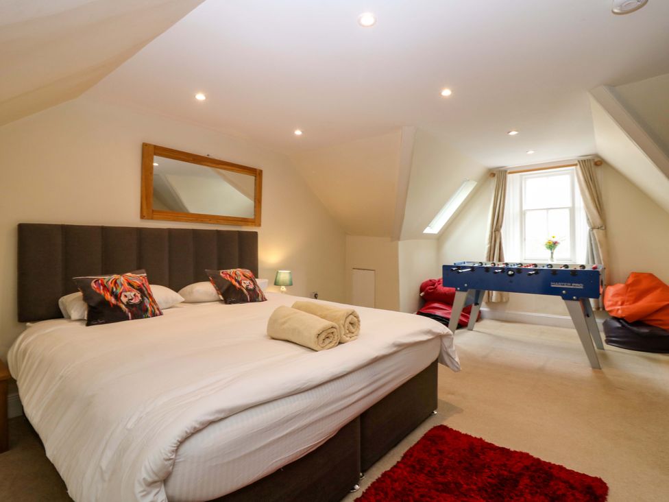 A bedroom with a bed and foosball table at Tayview in Killin