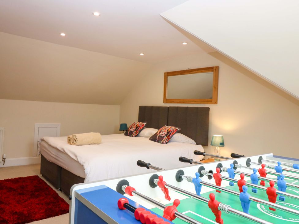 A bedroom with a bed and a foosball table at Tayview in Killin