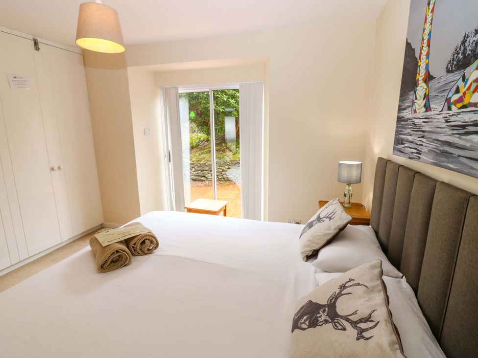 A bedroom with a bed and towels at Tayview in Killin