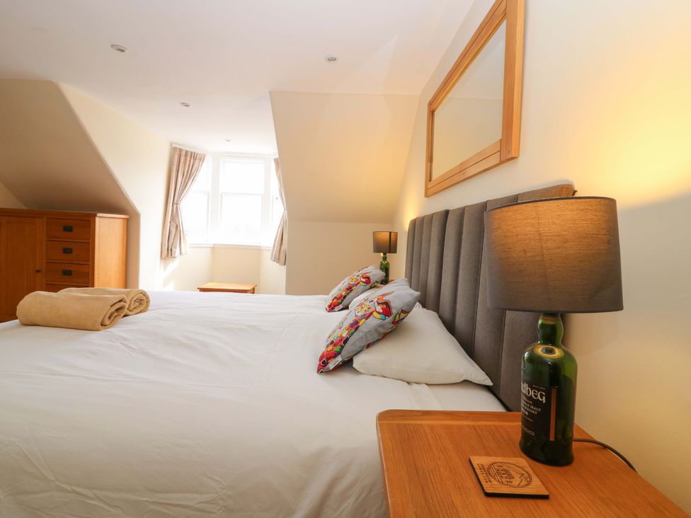 A bedroom with a bed and storage at Tayview in Killin