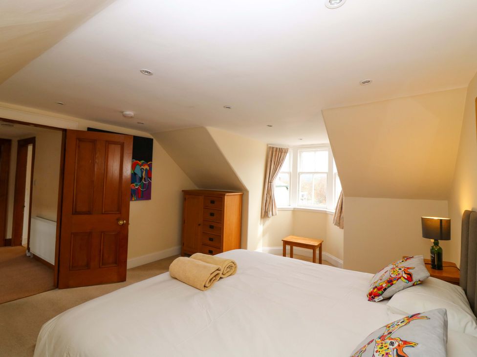 A bedroom with a bed and a table at Tayview in Killin