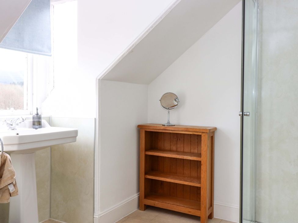 A bathroom with a sink and shelf at Tayview in Killin