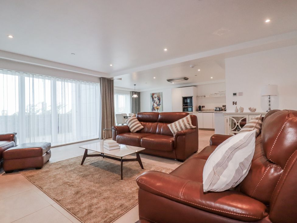 A living room with a sofa and coffee table at 13 Cliff Edge in Newquay