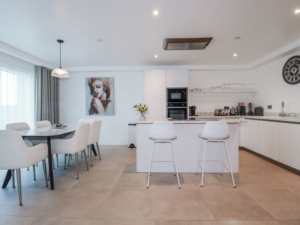 A kitchen with a dining area and an island at 13 Cliff Edge Newquay