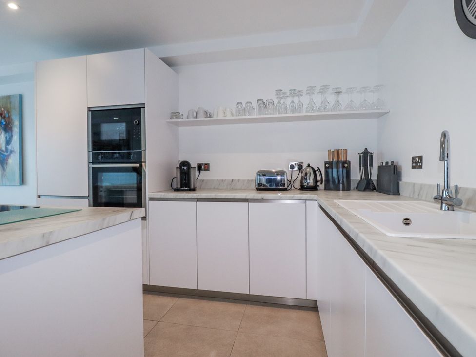 A kitchen with modern appliances and a countertop at 13 Cliff Edge in Newquay