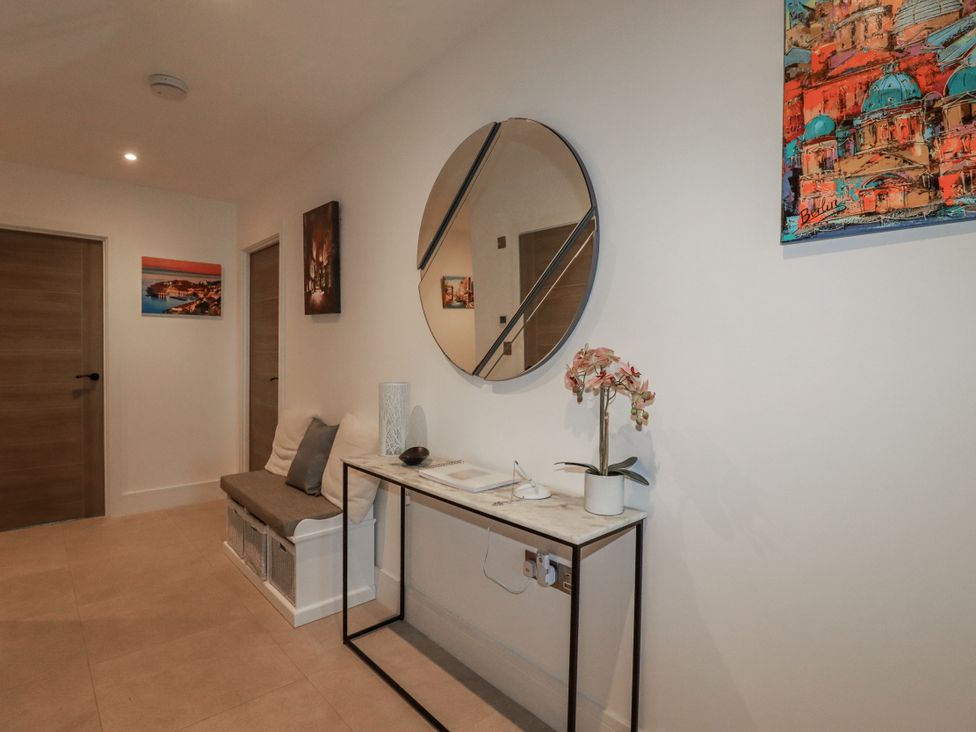 A hallway with a mirror and a table at 13 Cliff Edge Newquay