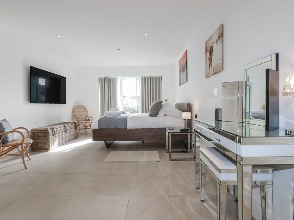 A bedroom with a bed and television at 13 Cliff Edge in Newquay