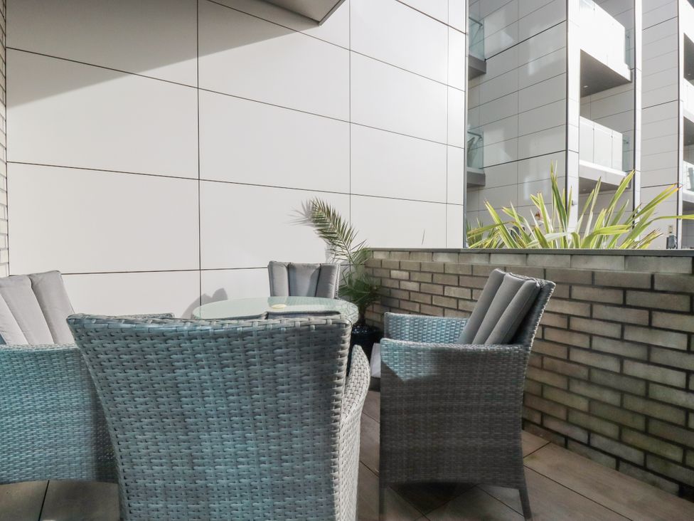 A balcony with a table and chairs at 13 Cliff Edge in Newquay